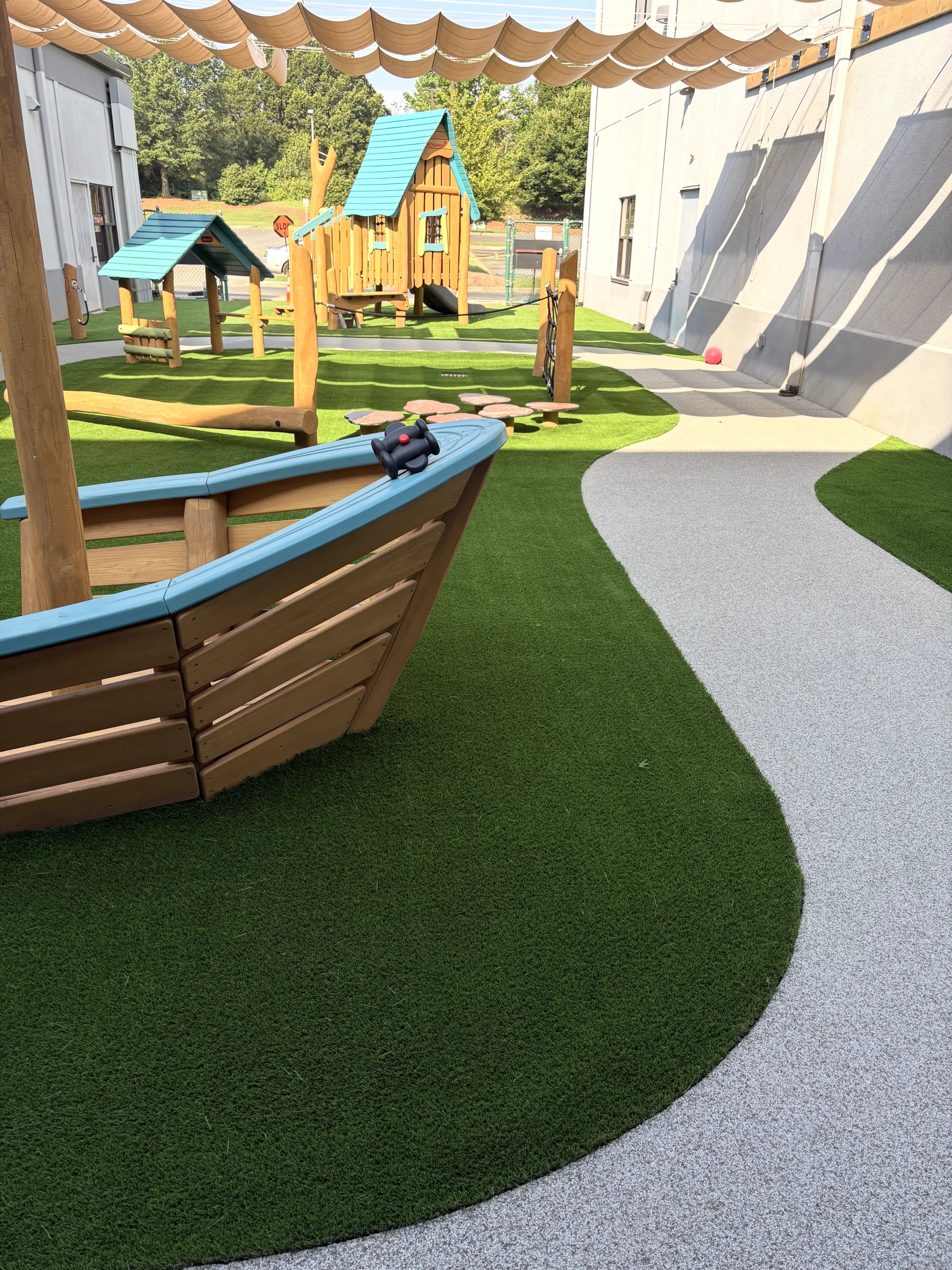 Grace Covenant Church playground turf with pirate ship play structure and winding rubber path — Huntersville NC