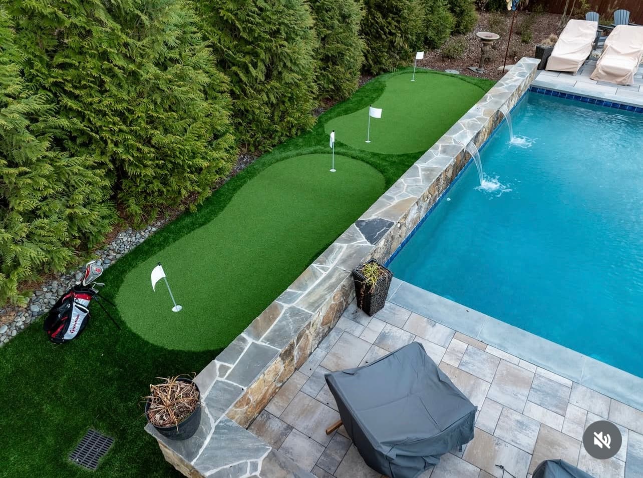 Poolside putting green with waterfall feature