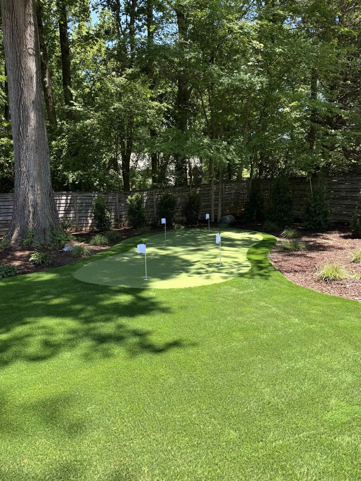 Putting Green & Full Backyard Lawn — Wooded Cedar Fence