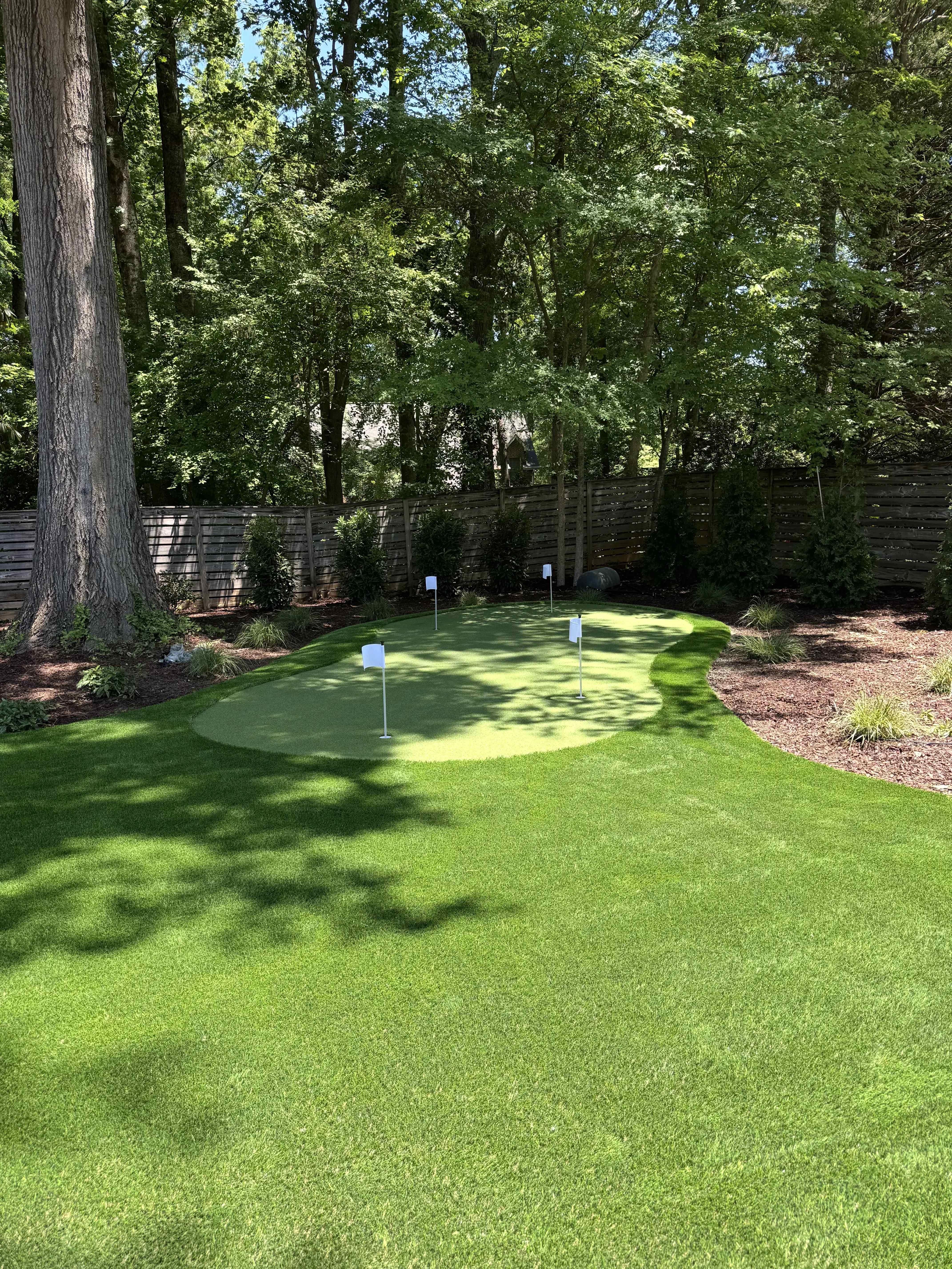 Lush backyard putting green and lawn by Atlantic Turf Specialists