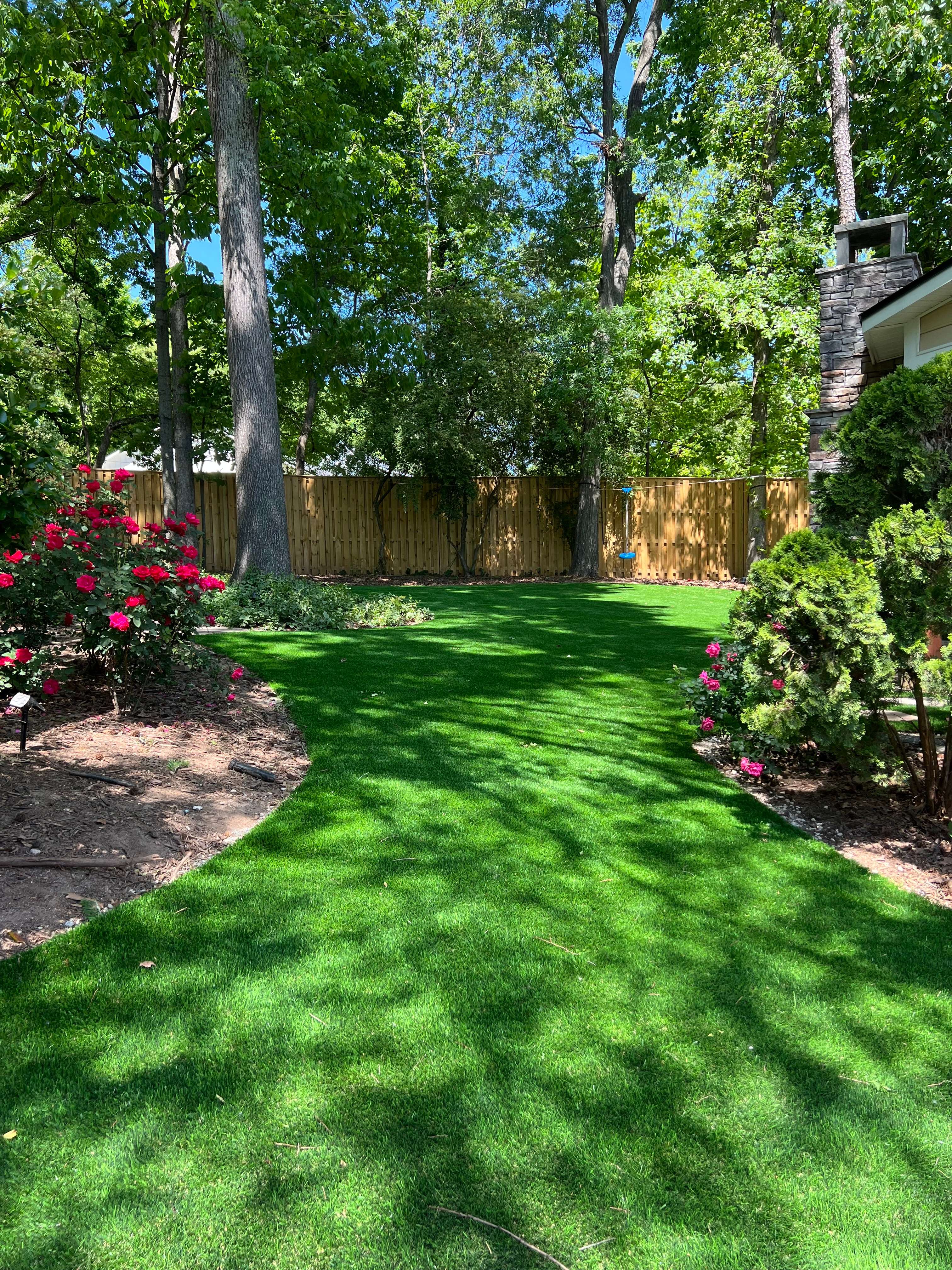 Manicured Charlotte garden with winding artificial turf path and landscaping